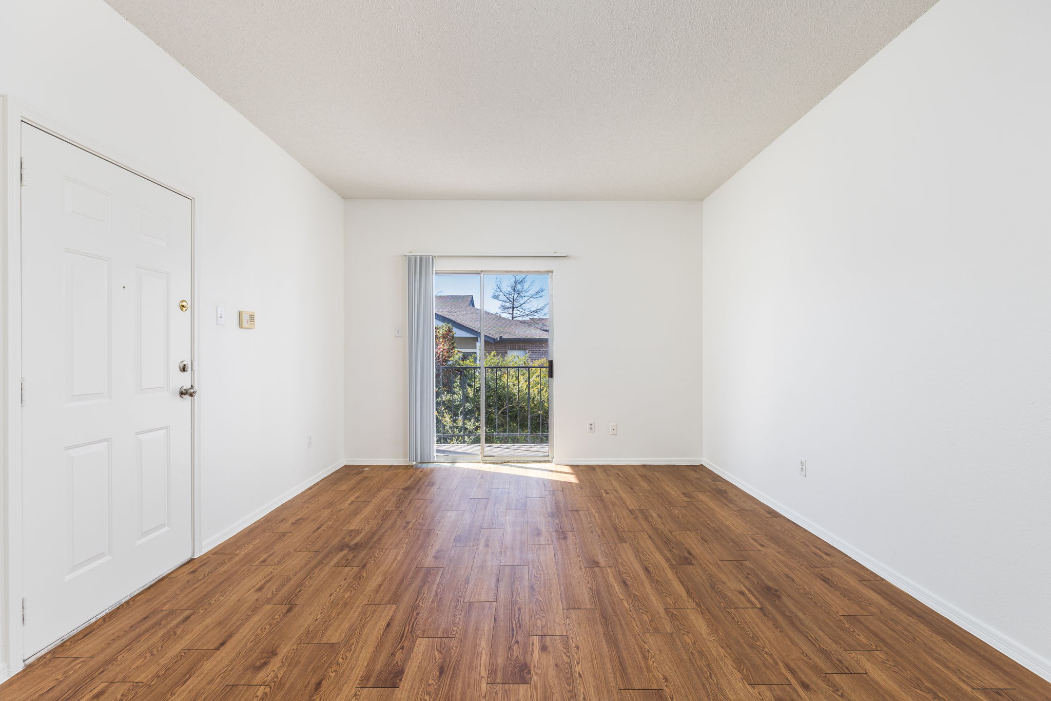 12166 Metric Boulevard, Unit 230 Austin, TX 78758 - Photo 13 of 32 a view of an empty room with wooden floor and a window