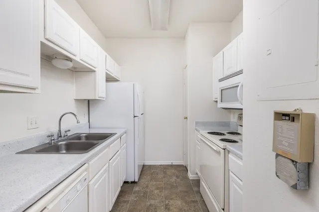 a kitchen with stainless steel appliances a sink and cabinets