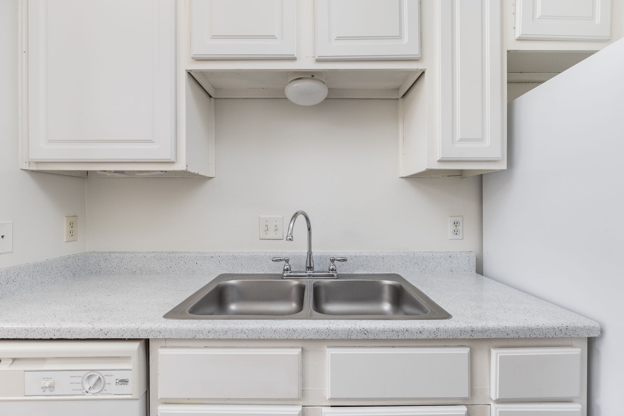 12166 Metric Boulevard, Unit 230 Austin, TX 78758 - Photo 10 of 32 a kitchen with a sink and cabinets