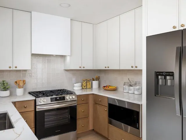 a kitchen with cabinets and appliances