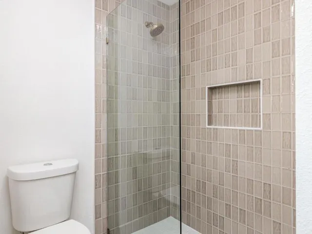 a bathroom with a toilet and shower