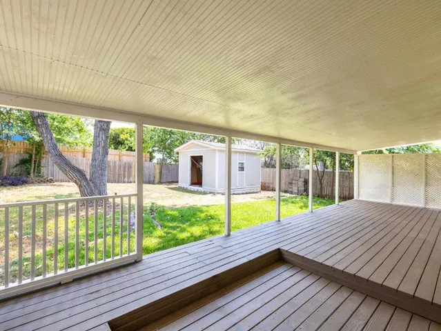 a view of a deck with a big yard