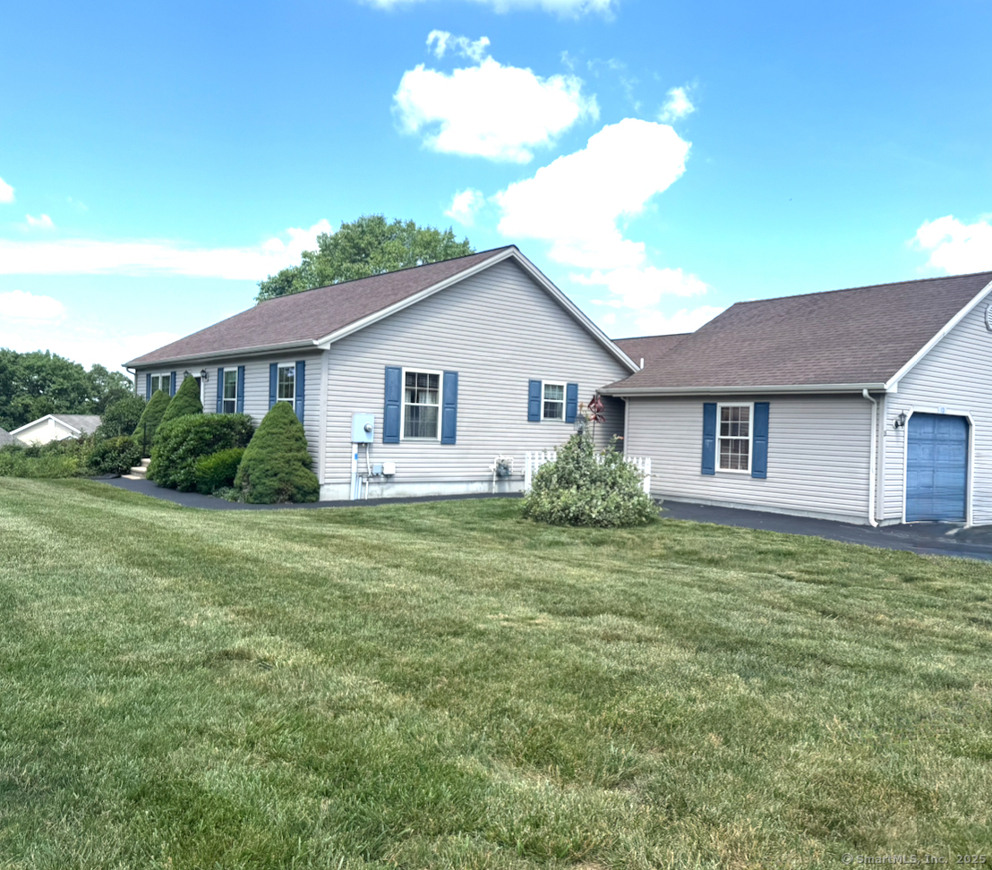 13 Oriole Drive, Unit 13 Killingly, CT 06239 - Photo 1 of 1 a front view of a house with a garden