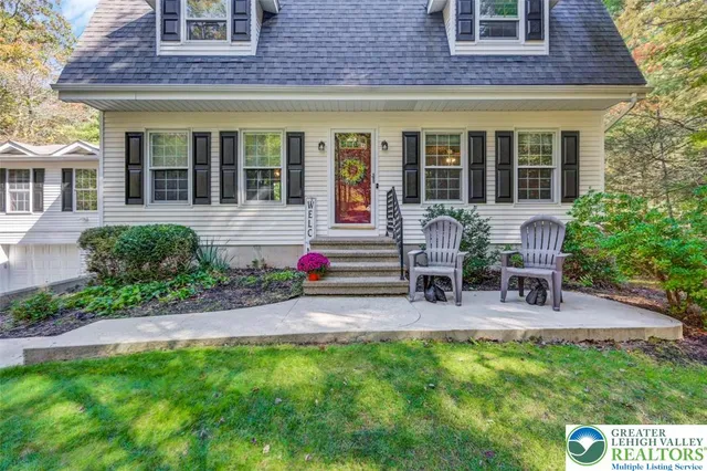 a house view with a sitting space and garden