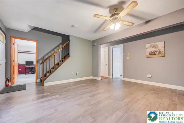 a living room with furniture and large windows