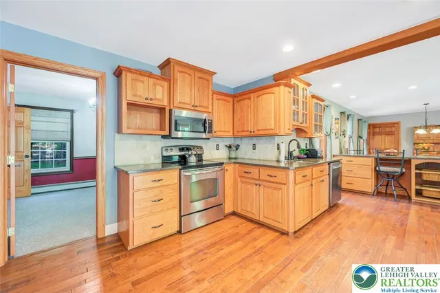 a living room with furniture flat screen tv and a large window