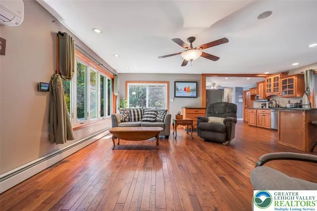 a living room with furniture and a floor to ceiling window
