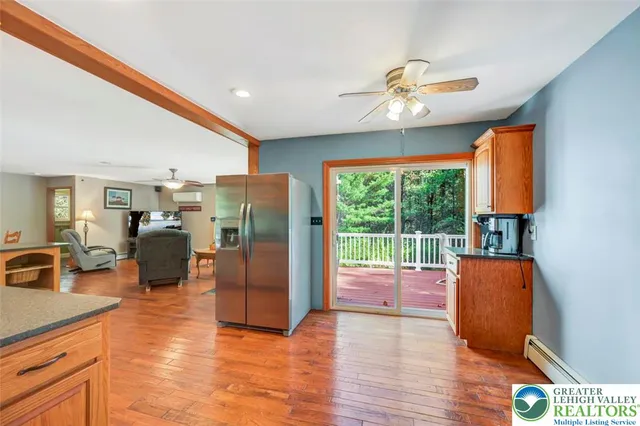 a bathroom with a granite countertop toilet sink and mirror