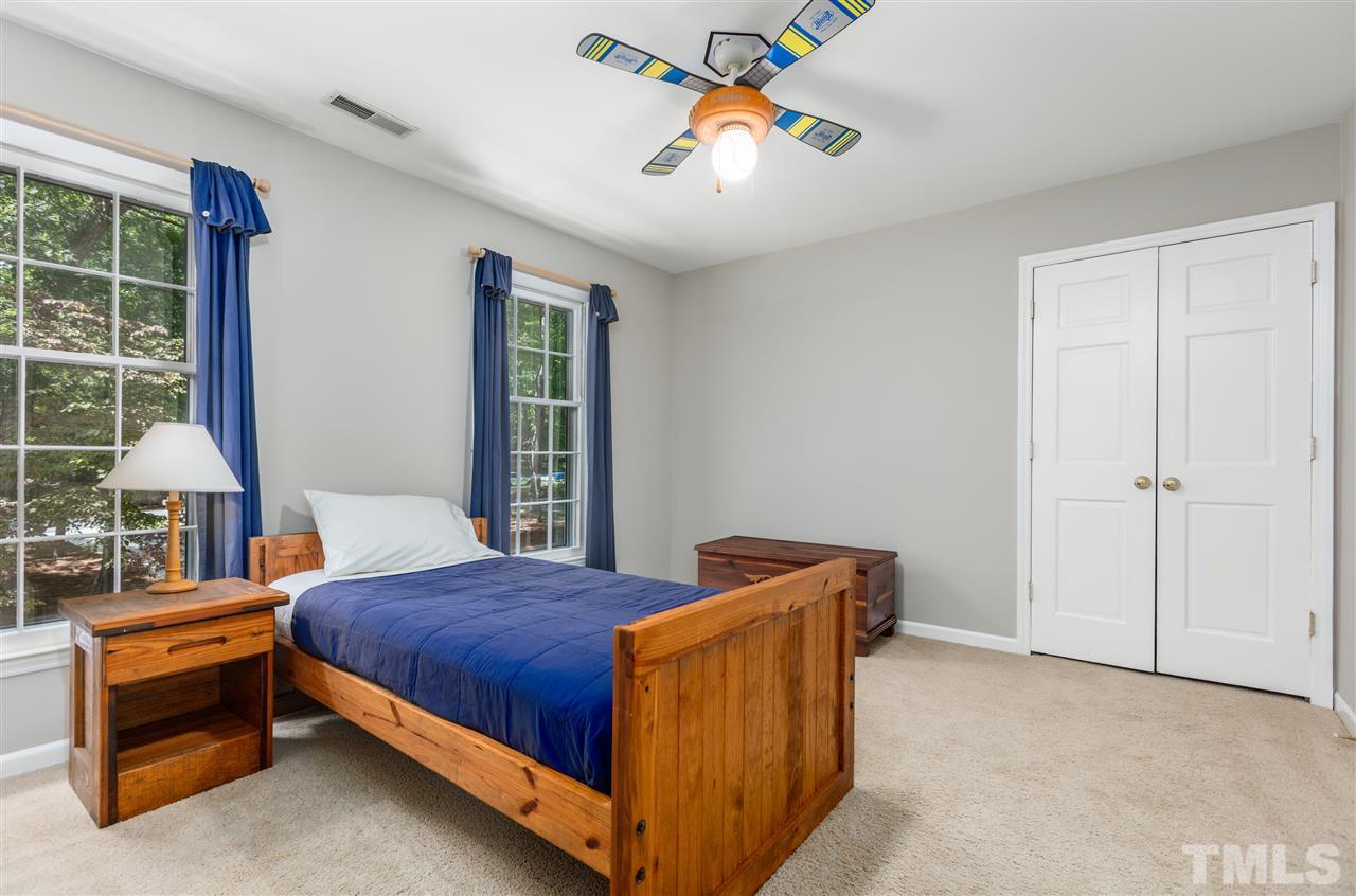 11508 Hardwick Court Raleigh, NC 27614 - Photo 18 of 30 a bedroom with a bed and a table