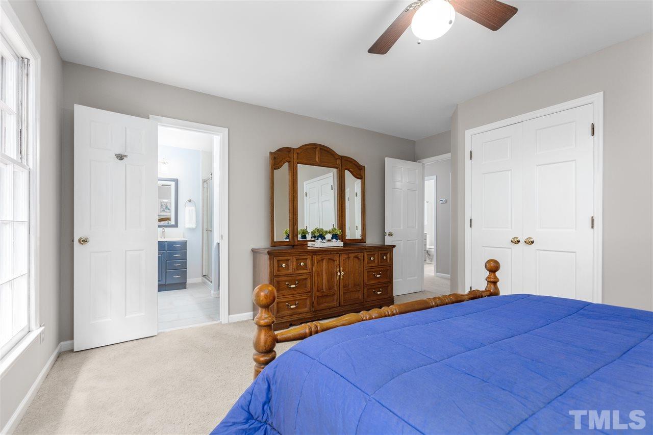 11508 Hardwick Court Raleigh, NC 27614 - Photo 23 of 30 a bedroom with a bed and a mirror on dresser