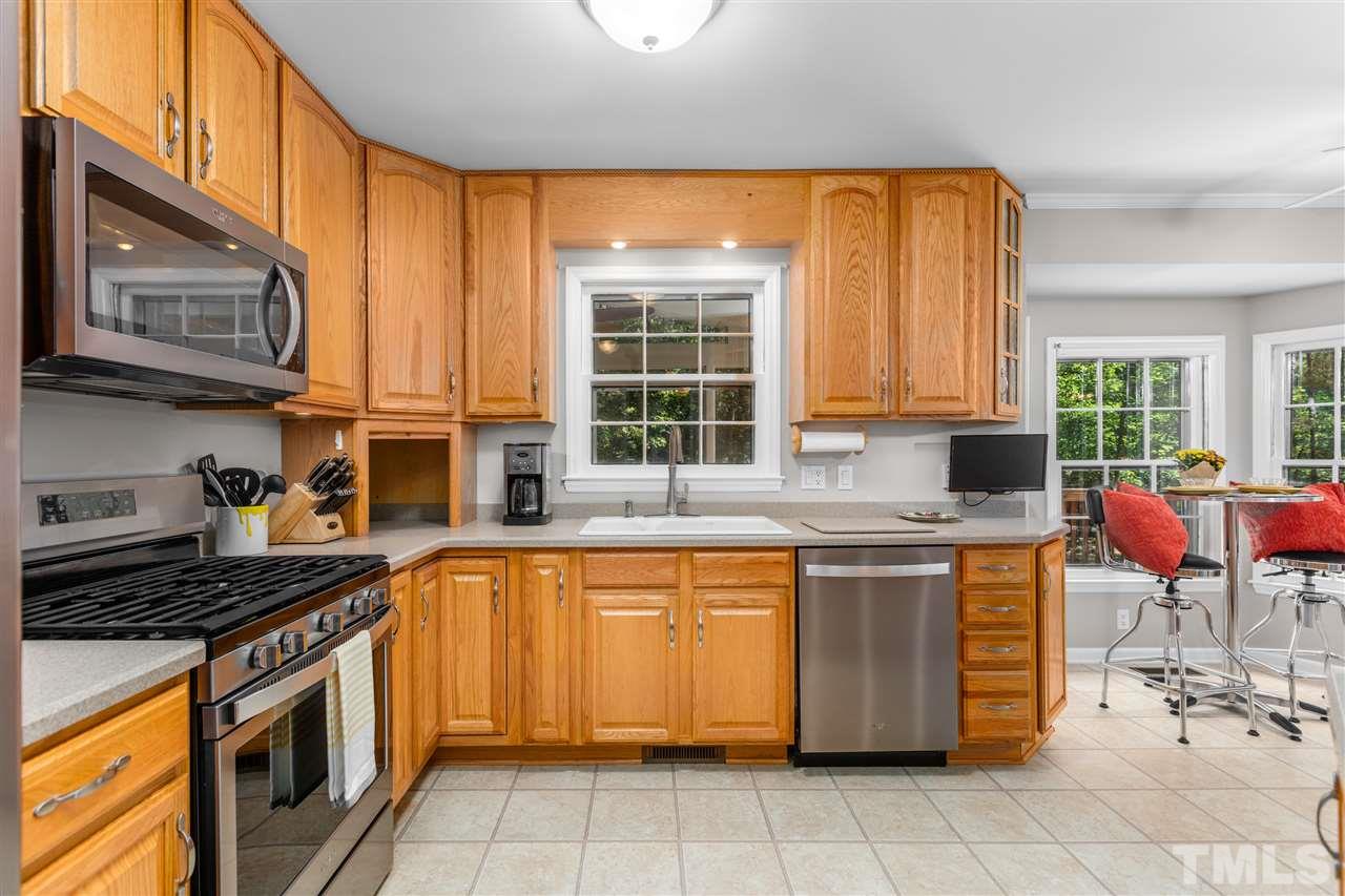 11508 Hardwick Court Raleigh, NC 27614 - Photo 10 of 30 a kitchen with stainless steel appliances granite countertop a stove a sink and a microwave