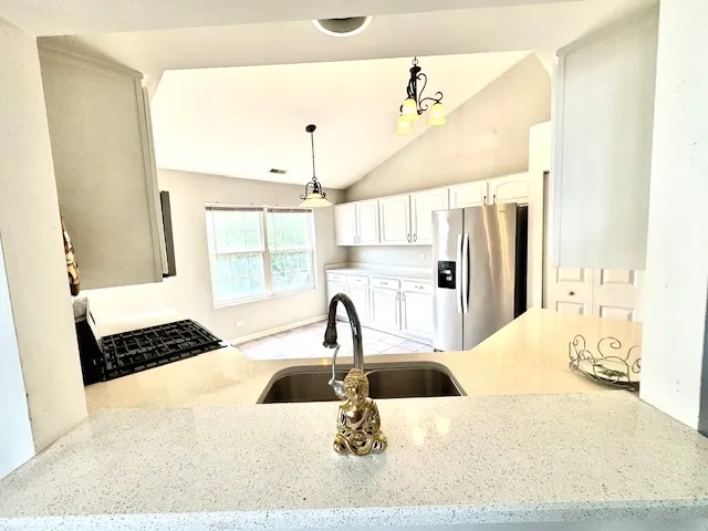 a kitchen with a sink appliances and cabinets