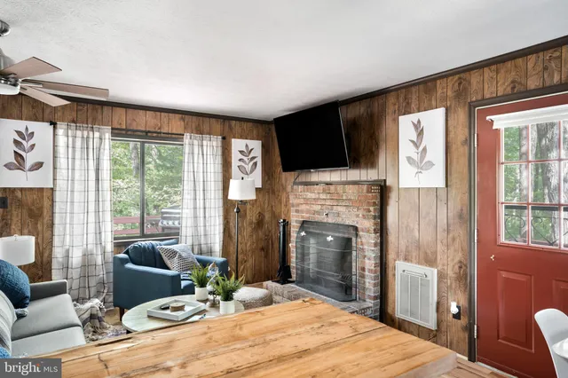 a bedroom with a bed a flat screen tv and a fireplace