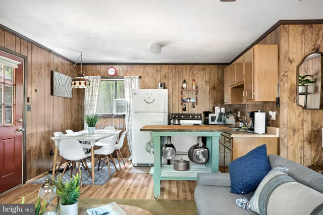 a living room with granite countertop furniture a dining table chairs and a large window