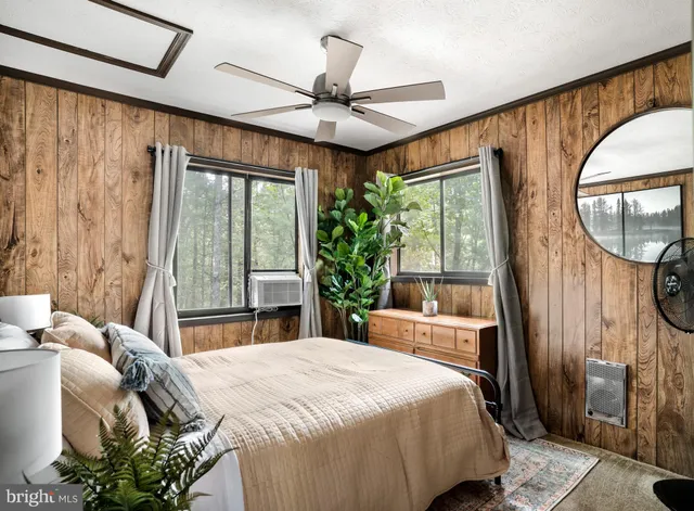 a bedroom with a bed mirror and window