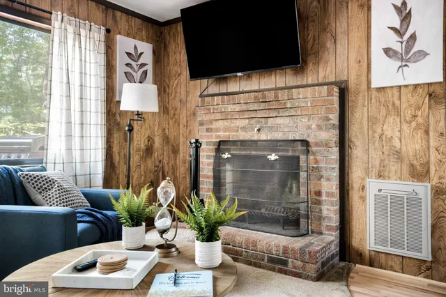 a living room with furniture and a fireplace