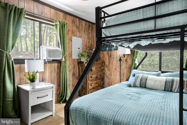 a bedroom with a bed and a large window