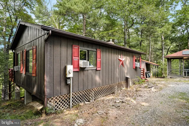 a backyard of a house with barbeque oven table and chairs