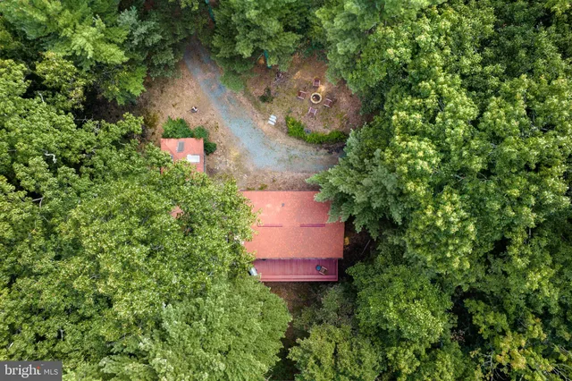 an aerial view of a house with a yard