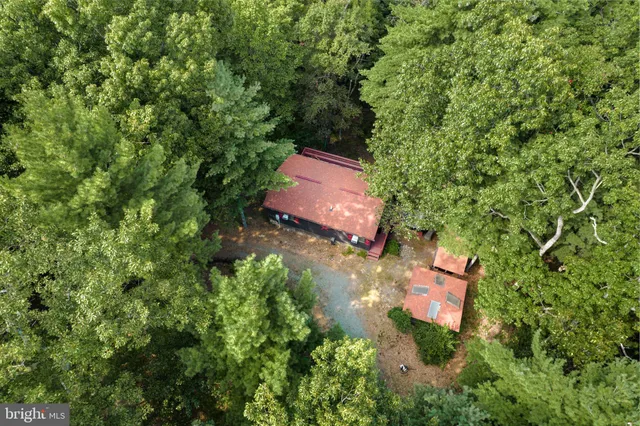 an aerial view of a house with a yard