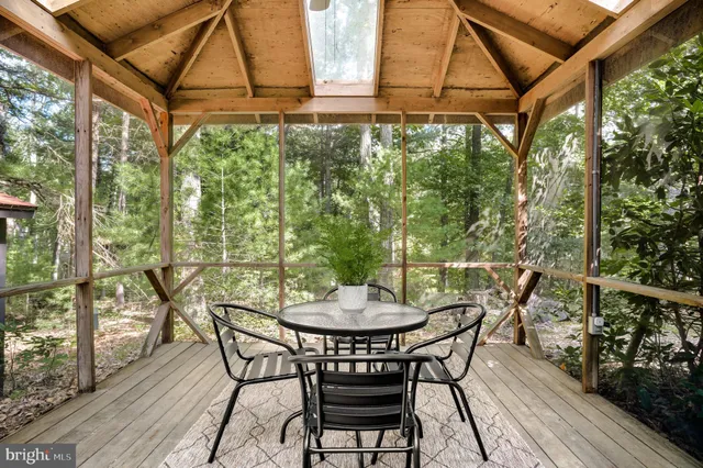 a view of a patio with table and chairs and wooden floor