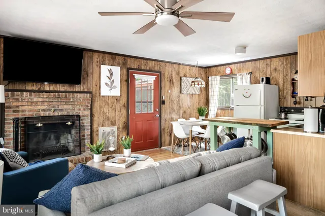 a living room with furniture fireplace and flat screen tv