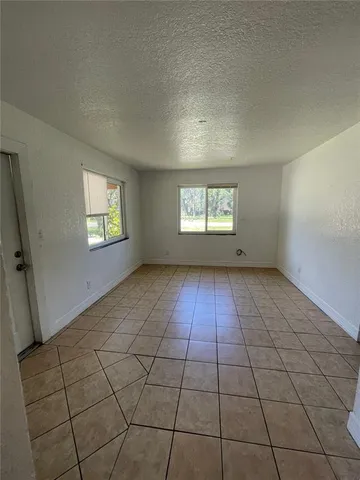 a view of an empty room and a window