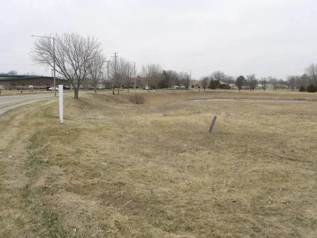 a view of a field with trees in the background