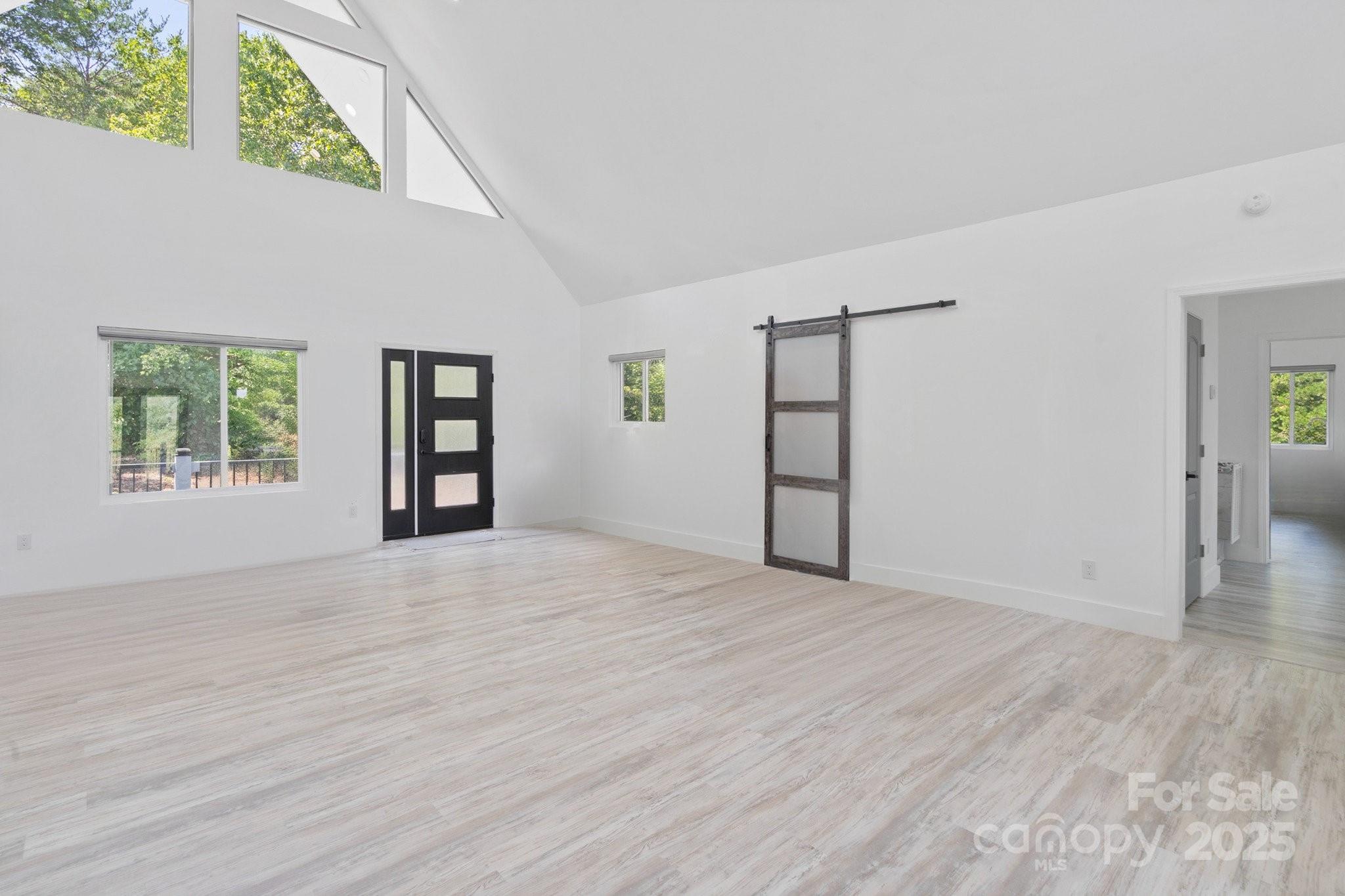 456 Hickory Loop Road Rutherfordton, NC 28139 - Photo 16 of 38 an empty room with wooden floor cabinet and windows