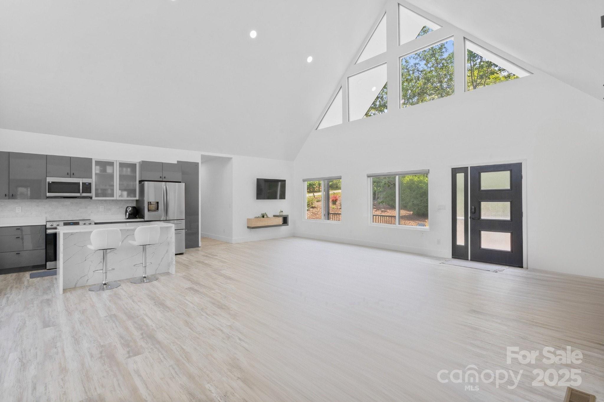 456 Hickory Loop Road Rutherfordton, NC 28139 - Photo 2 of 38 a big room with chandelier fan and windows