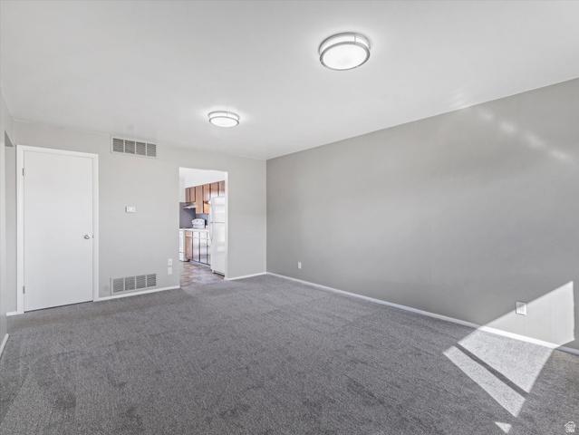 1478 North 75 West, Unit AD Sunset, UT 84015 - Photo 19 of 26 Unfurnished room featuring dark carpet and baseboards