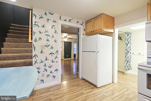 a white refrigerator freezer sitting inside of a kitchen