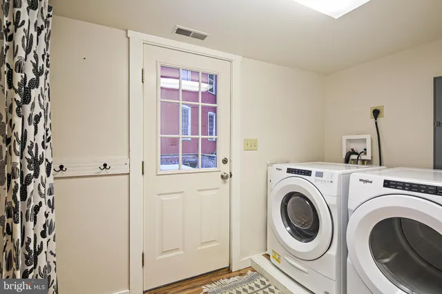 a view of a hallway with washer and dryer