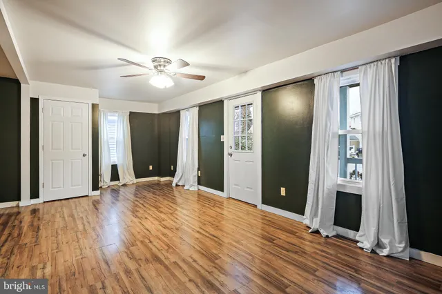 a view of a room with wooden floor and stairs
