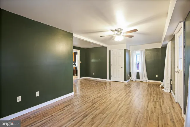 wooden floor in an empty room with a window