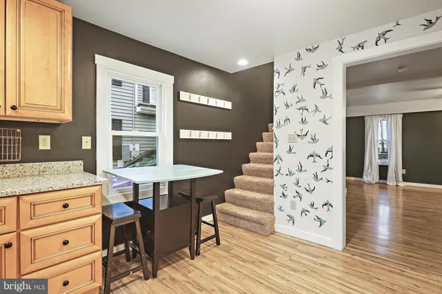 a kitchen with granite countertop a table and chairs in it