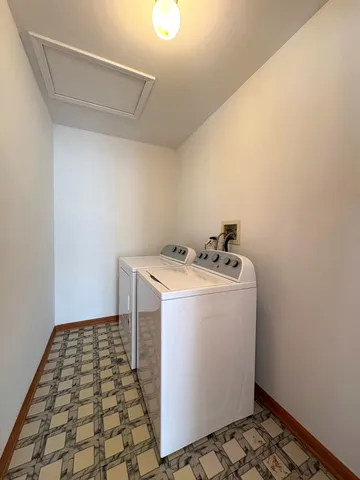 a utility room with a sink a vanity and a window