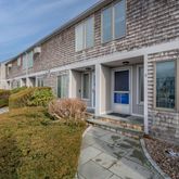 a front view of a house with large windows