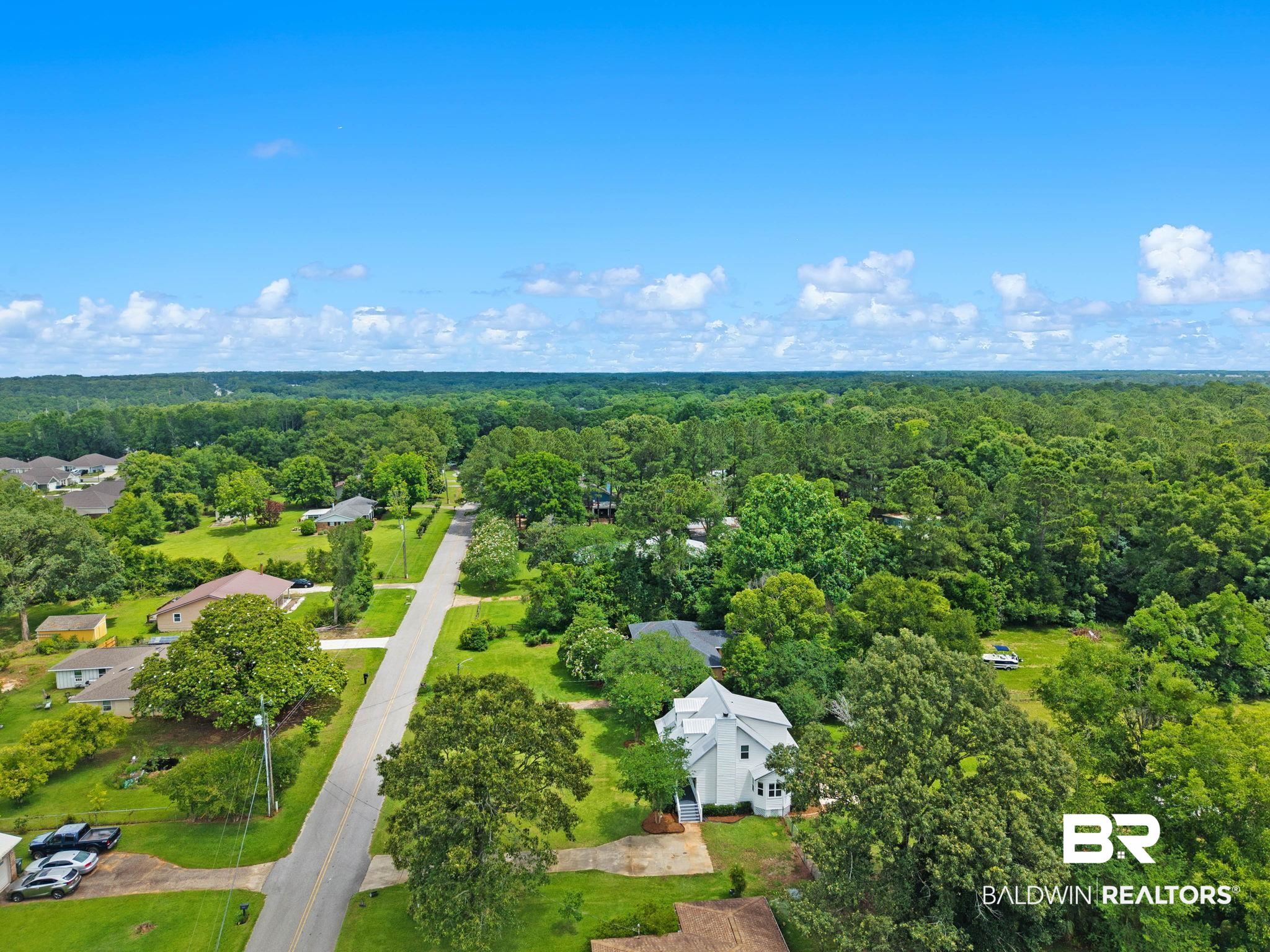 22810 High Ridge Road Fairhope, AL 36532 - Photo 67 of 78 White multi-story residence with a gabled roofline and multiple windows