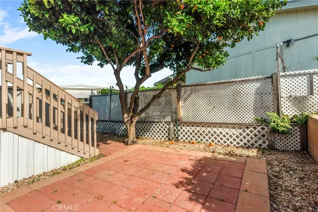 a view of a house with wooden fence and a floor to ceiling window