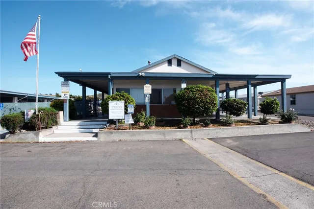 a living room with furniture a flat screen tv and a table