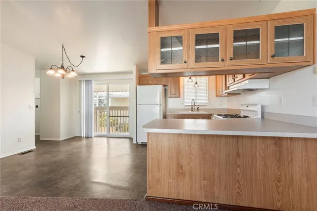 a kitchen with a sink cabinets and wooden floor
