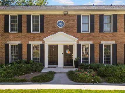 a view of a brick building with a large windows and a potted plant