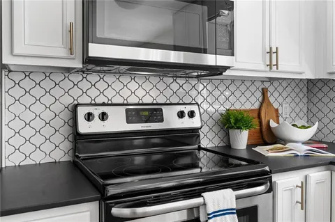 a stove top oven sitting inside of a kitchen