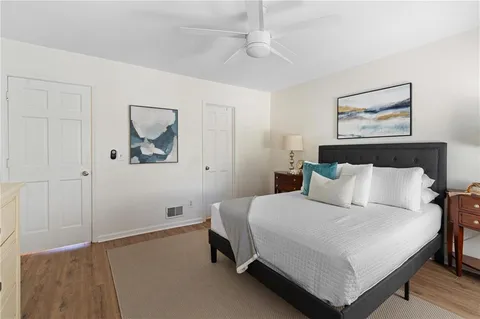 a bedroom with a bed and a painting on the wall