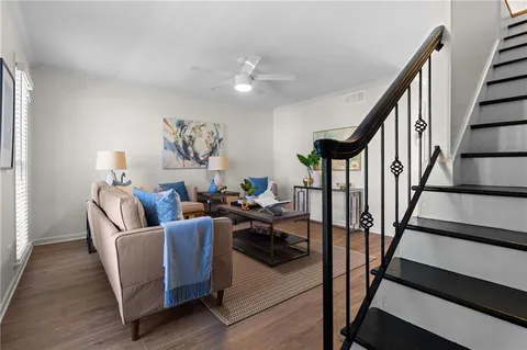 a living room with furniture and stairs