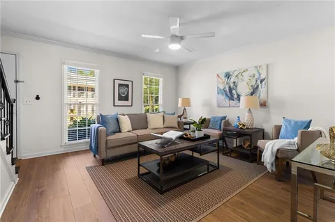 a living room with furniture and wooden floor