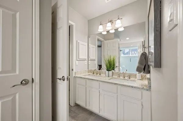 a bathroom with a sink vanity and a mirror