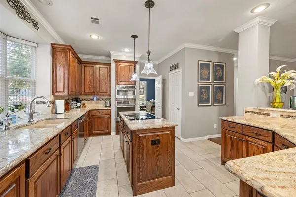 a kitchen with a stove sink and cabinets