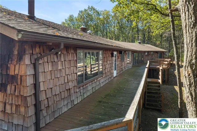 a view of a house with a door and wooden fence